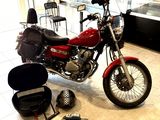 a red motorcycle that is sitting in a room