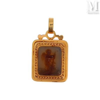 a close up of a gold pendant with a picture of a man