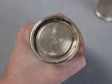 a person holding a silver cup in their hand