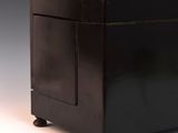 a small black chest with a drawer on top of it