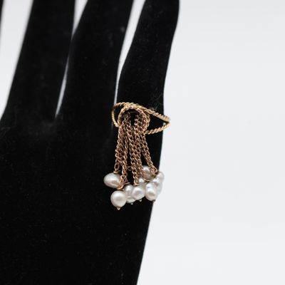 a close up of a person ' s hand with a ring on it