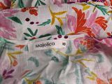 a close up of a floral dress with a label on it