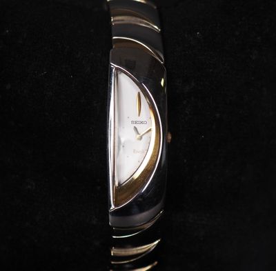 a close up of a watch on a black surface