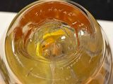 a glass of liquid sitting on top of a white table