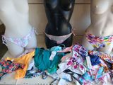 three mannequins in front of a display of underwear