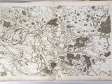 an old book with a map on it sitting on a table