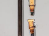 a flute and two other instruments on a white surface