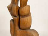 wooden sculpture of a couple holding hands on a white background
