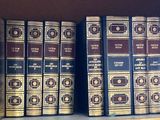 many books that are on a shelf in a library
