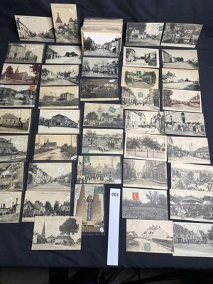 a lot of old black and white pictures on the table