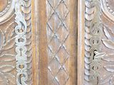 a close up of a wooden door with intricate carvings on it