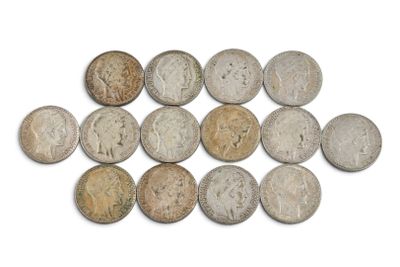 un gros plan sur un tas de vieilles pièces de monnaie posées sur une surface blanche