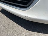 a close up of a car ' s front bumper and grille