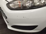 a close up of a car ' s headlight and the front end of it