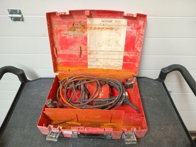 a red tool box with wires in it on a table