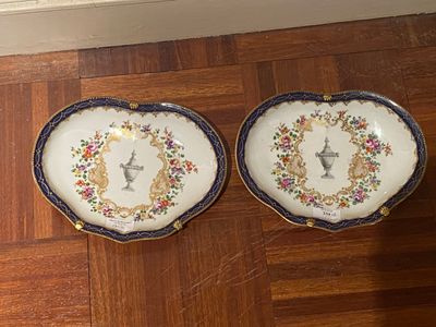 two plates that are sitting on a wooden floor