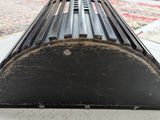 a close up of a black metal object on a floor