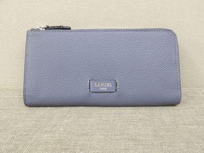 a small blue purse sitting on top of a couch