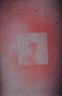 a picture of a man on the back of a man ' s shoulder