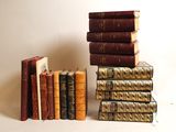 several books stacked on top of each other on a white surface