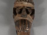 an image of a wooden mask on a white surface