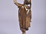 bronze statue of a woman holding a bird on a marble base