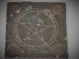 a stone with a pentagram on it on a wall