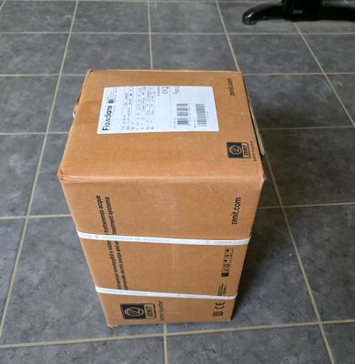 a box that is sitting on the floor next to a chair