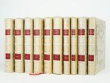 six books are stacked on top of each other on a white surface