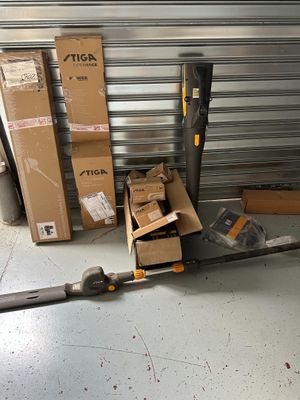many boxes and a pair of scissors sitting on the floor