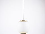 a white and gold pendant light hanging from the ceiling