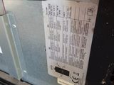 the back of a gas furnace with a paper label on it