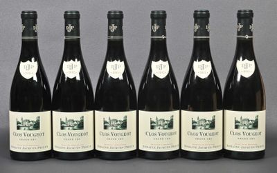 six bottles of wine are lined up in a row on a table