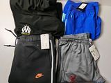 three pairs of pants and a jacket on a table
