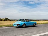 a blue car that is driving down the road