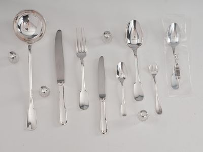 a lot of silver spoons and forks on the table