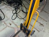 a fork lifter that is sitting on the floor in a garage