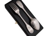 two forks and spoons in a black box on a white background