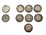 a group of silver coins on a white background