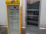 two refrigerators that are next to each other on the ground