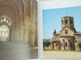 a person holding a book with a picture of a church in it
