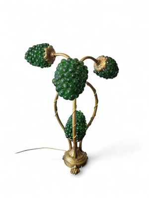 a close up of a green lamp on a white surface