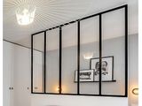 a bedroom with a bed and pictures on the wall