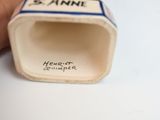 a hand holding a small cup that has a label on it