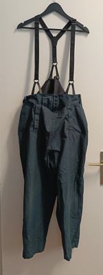 a blue pants hanging on a hanger on a door