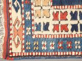 an image of a blue, red, and white rug with a design on it