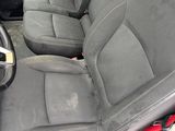 the interior of a car with black seats and red trims
