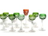 six wine glasses are lined up in a row on a white surface