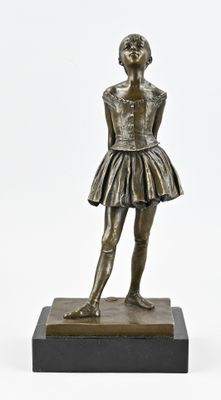 bronze statue of a young girl in a skirt standing on a marble base