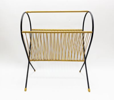 a black and gold magazine rack with a magazine holder on it